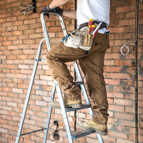 electrician-with-tools-working-construction-site-repair-handyman-concept - G Construction